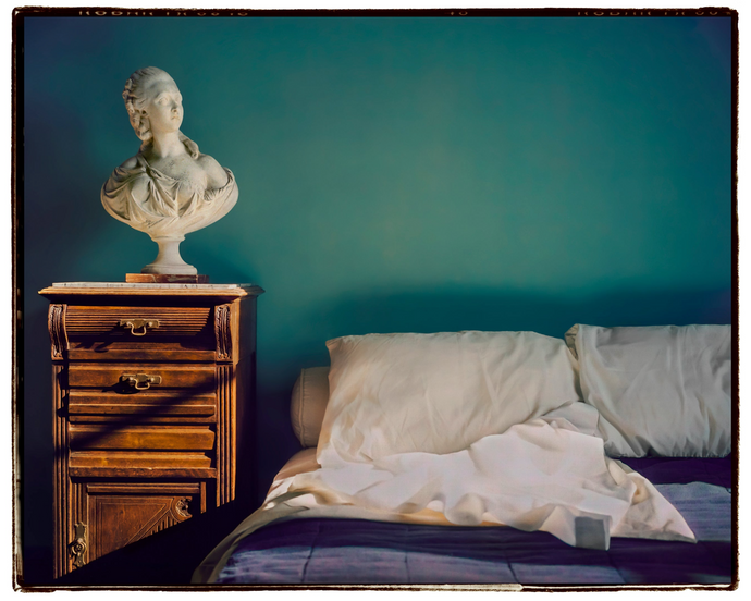 travel photo of beautiful green hotel room with marble bust