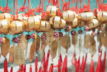 Load image into Gallery viewer, color photograph of buddhist prayer offerings in the breeze in hong kong china
