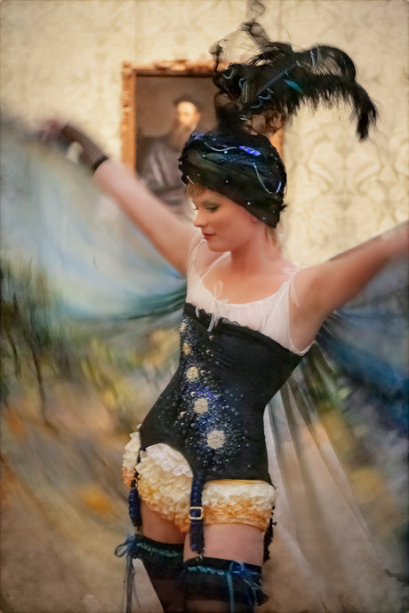 impressionism inspired photograph of beautiful woman dancing in costume with feather headress