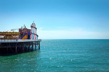 Load image into Gallery viewer, color photo of brighton pier amusement park with helter skelter and merry go round
