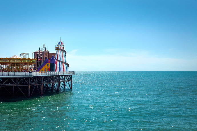 color photo of brighton pier amusement park with helter skelter and merry go round