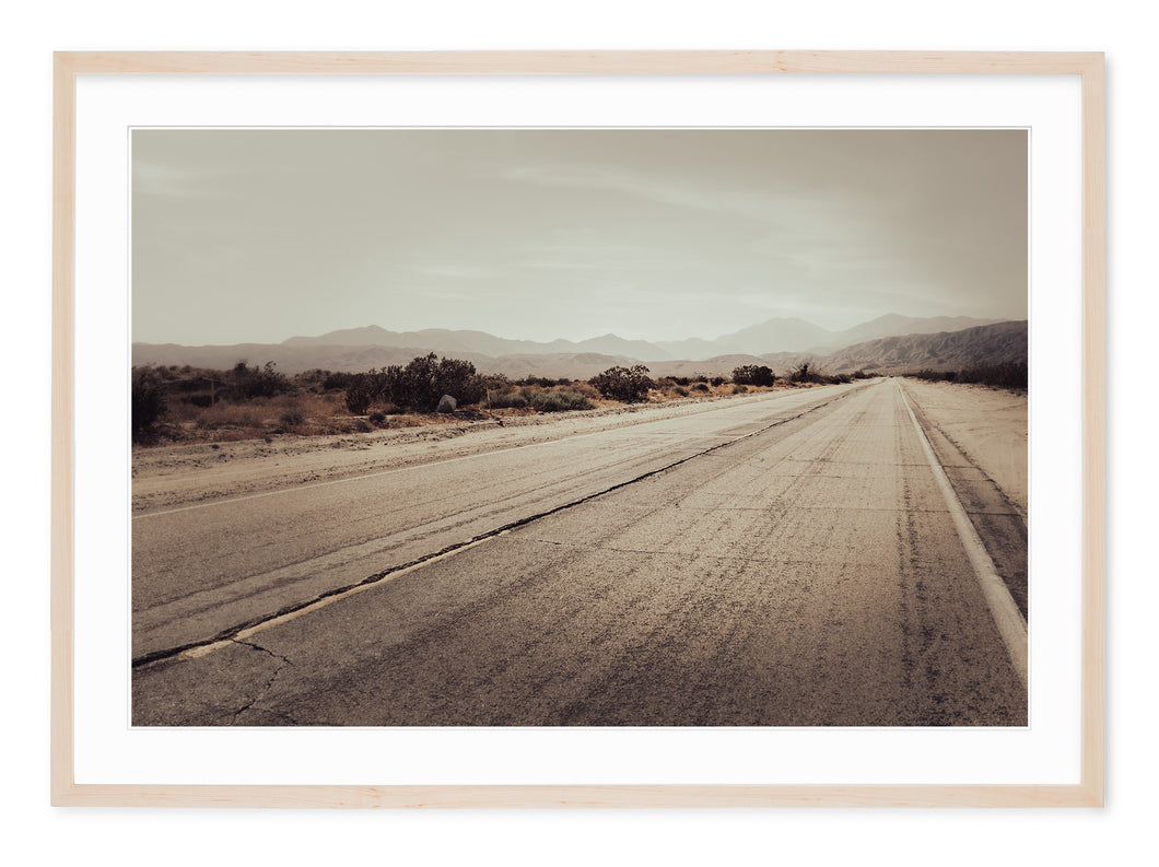 desert highway just outside of joshua tree national park in neutral tones
