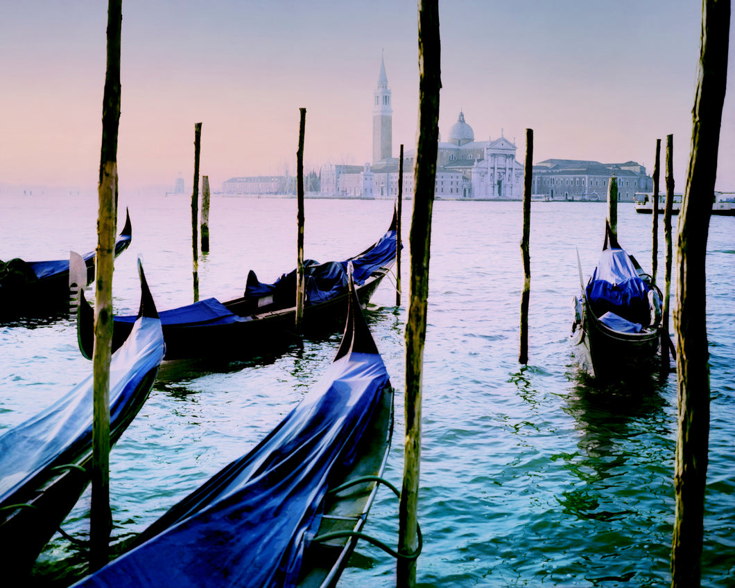 soft pastel image of gondolas at dawn in venice, italy