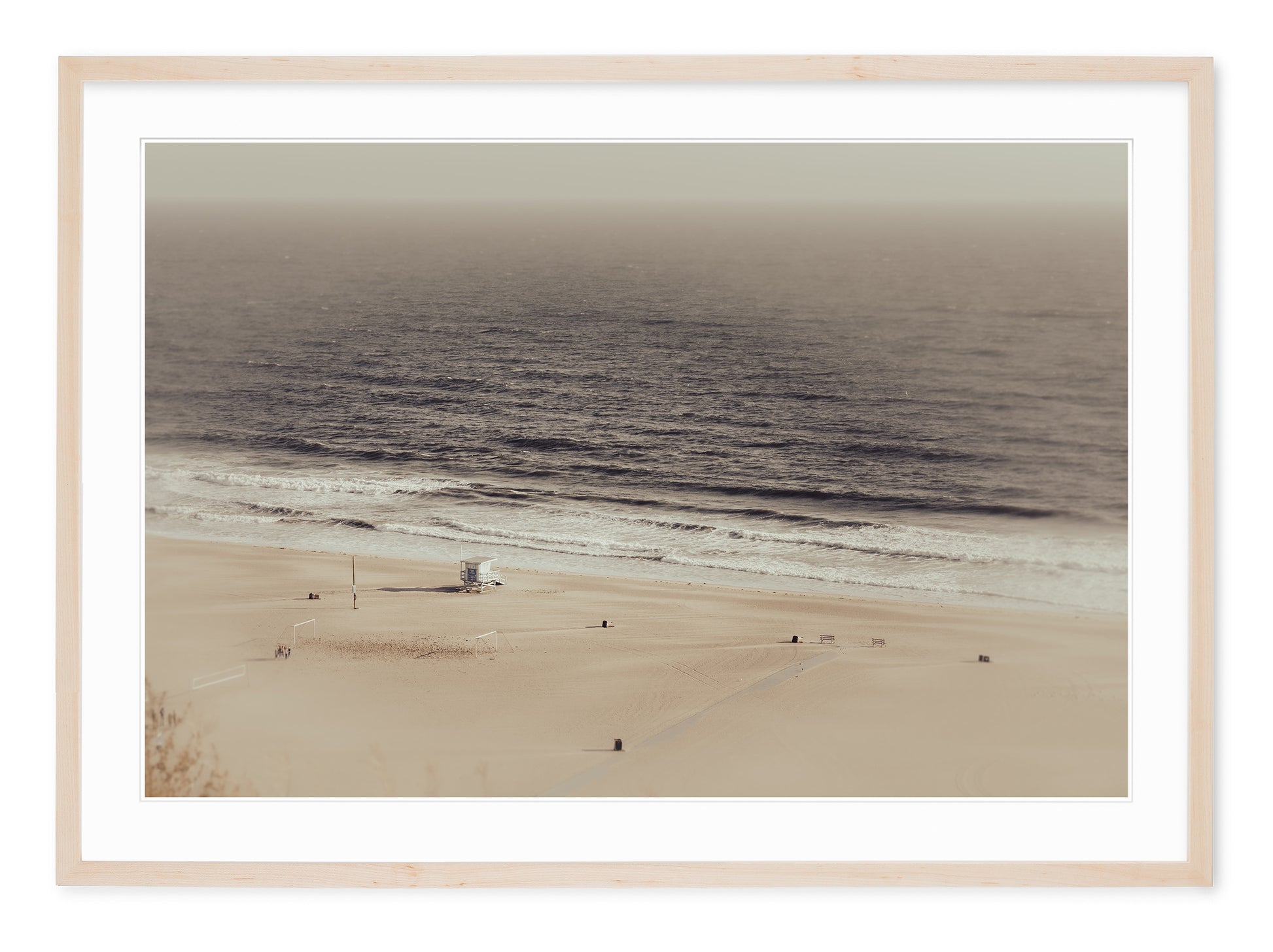 neutral tone landscape of deserted beach with lifeguard hut in winter