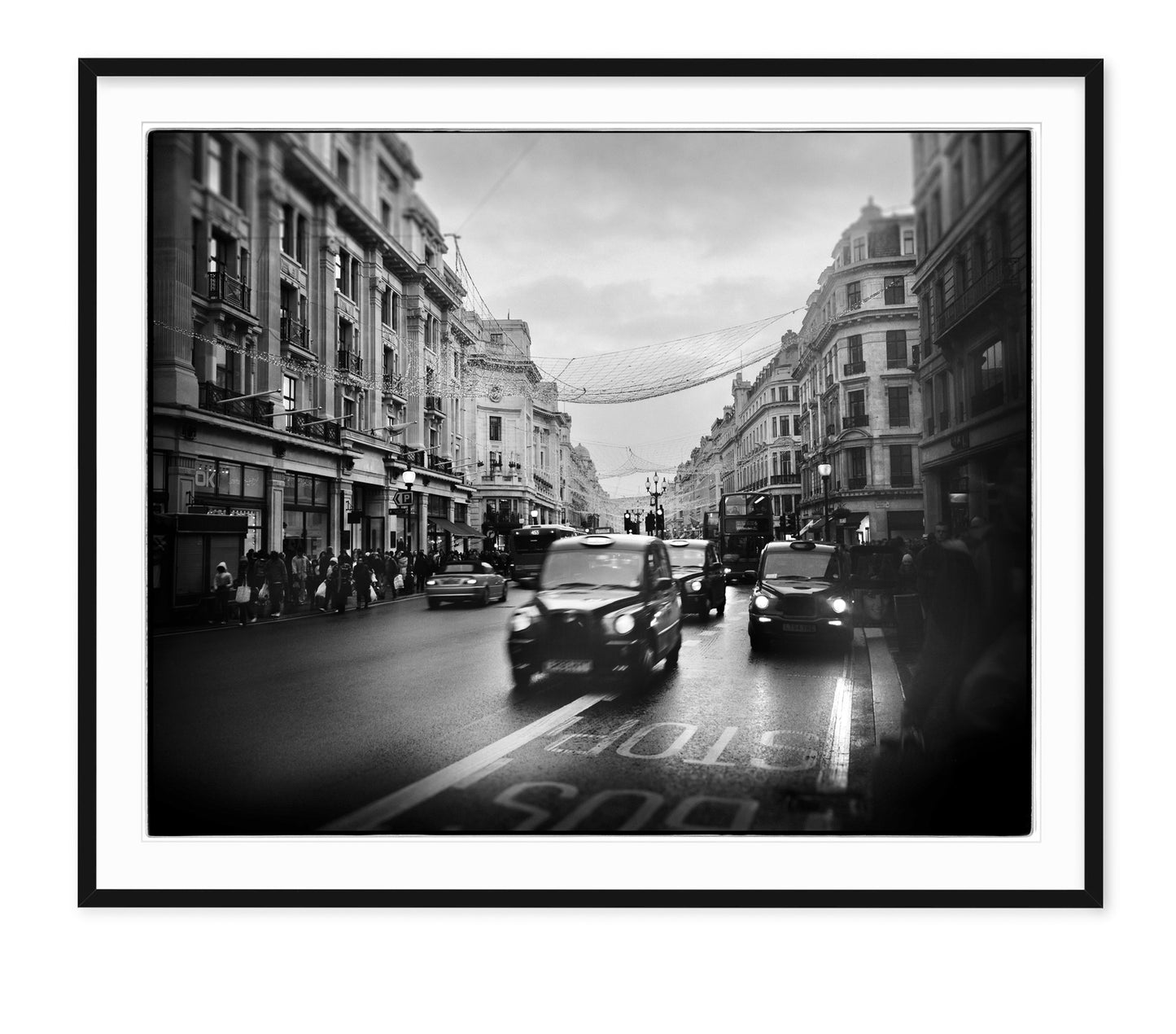 black taxi cabs speed down regent street in london