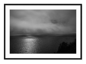 black and white landscape of sun through fog over loch ness in scotland