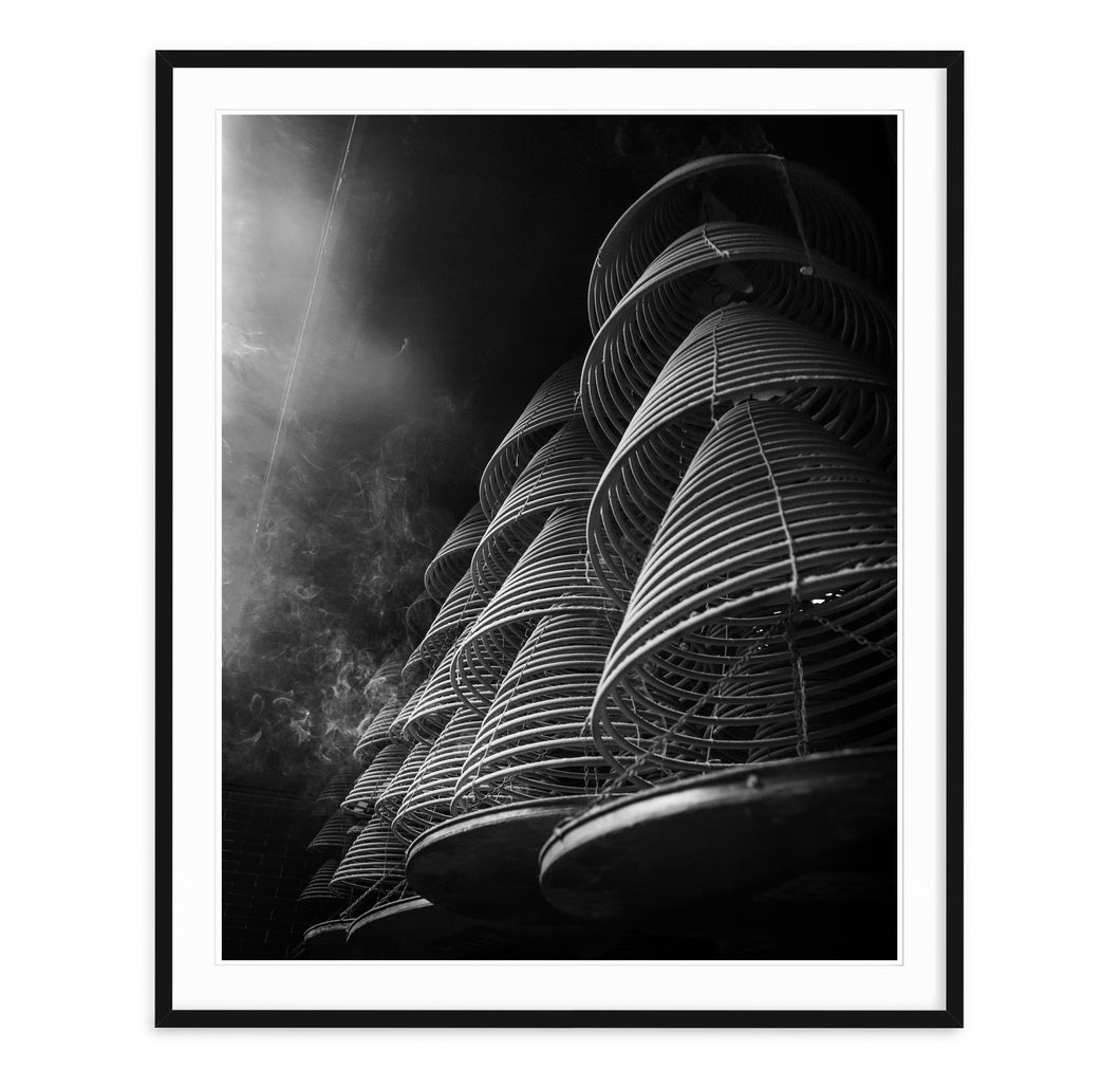black and white fine art image of incense burning in a temple in hong kong china