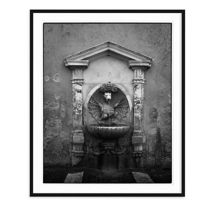 black and white fine art image of nasone fountain in rome italy with dragon