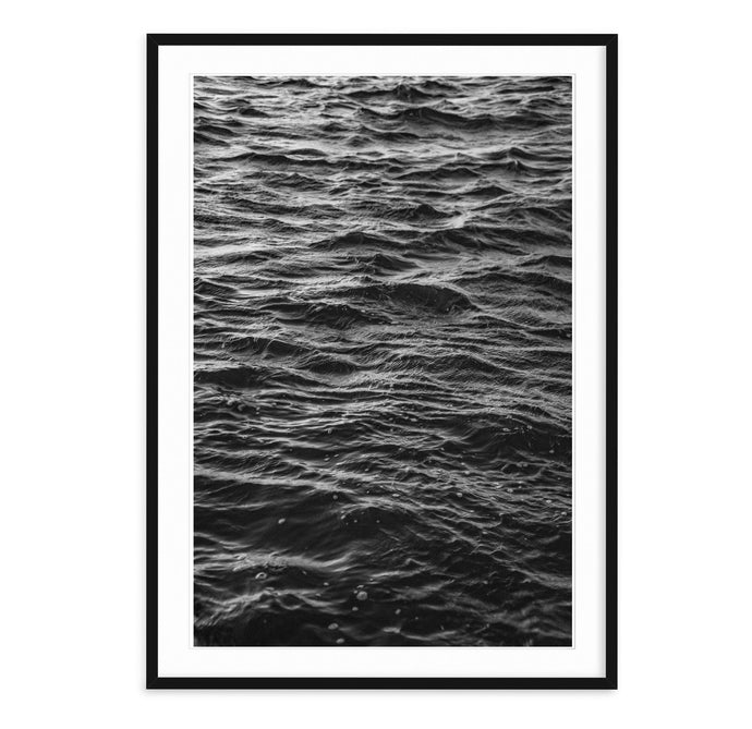 black and white fine art landscape of dark, rippling ocean water in the style of joy division