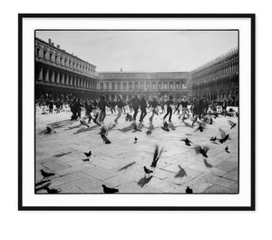 black and white fine art travel photo of teenagers dancing in circle on st marks square in venice italy