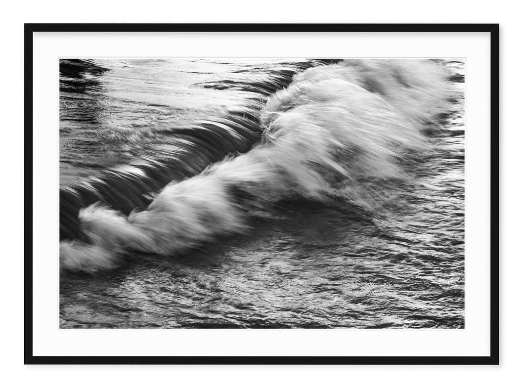 black and white fine art photo of waves crashing on beach